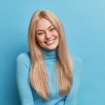 Happy young woman in blue jumper